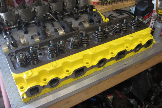 The refinished cylinder head with new valves installed, and a new coat of paint.