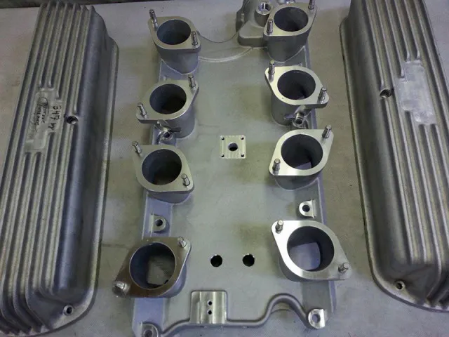 The valve covers and intake manifold were modified to use a custom PCV/breather system. Valve covers also had the Edelbrock logo milled off so that the customer's design could be milled in its place.