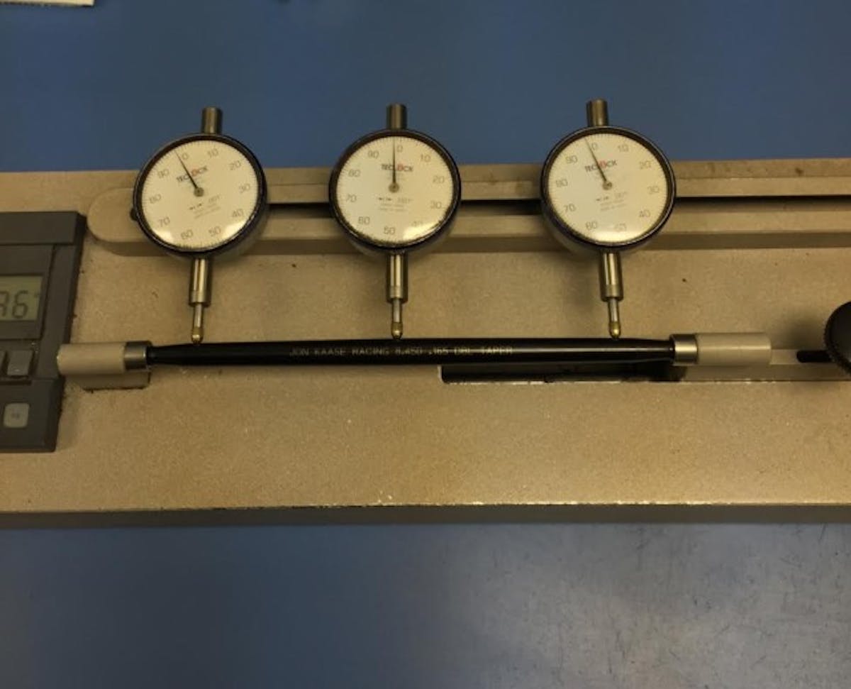 A pushrod in the fixture to check for runout.