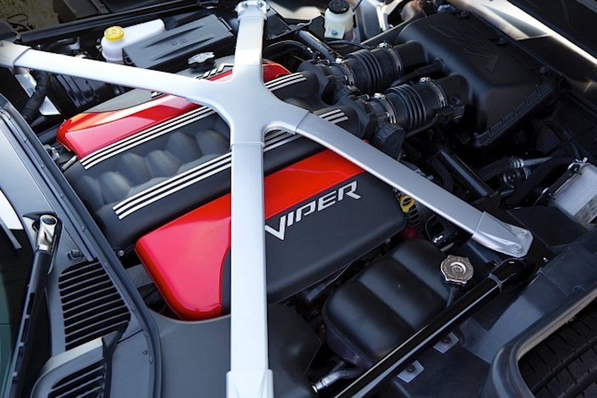 Under the hood of the 2015 Dodge Viper SRT models is the all-aluminum, mid-front 8.4-liter V-10 engine that delivers 645 horsepower and 600 lb.-ft. of torque – the most torque of any naturally aspirated sports car engine in the world. The aluminum “X” brace ties the suspension pickup points to the magnesium cowl super casting and contributes to improved torsional rigidity and stiffness.