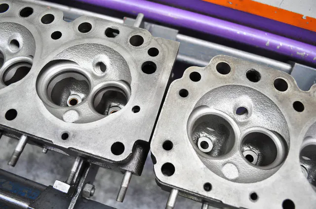 A comparison of the 245 (left) and the 265's combustion chambers  (right).  Even with larger 265-style valves the 245 head couldn't match the 265's performance on the flow bench. More on this down below.