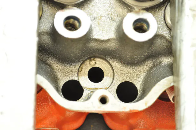 Problems can crop up in the most unsuspecting places; in this case, the head bolt recesses were leaking water. Powerhouse machined the areas causing the problem, and pressed in custom  inserts secured by high grade sealant to solve the problem.