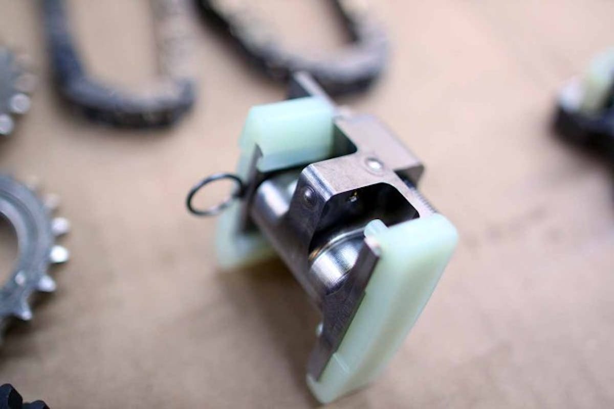 These modified tensioners change how the chain is tensioned, to prevent the links from whipping around as much as possible.