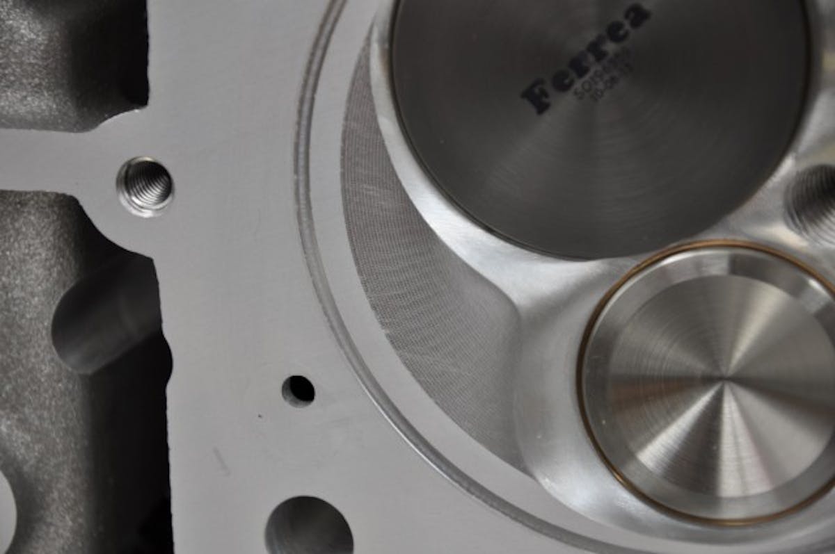 Laying back the combustion chamber's angles is an excellent way to reduce the quench and improve flame travel, especially in cylinder heads with flatter valve angles.