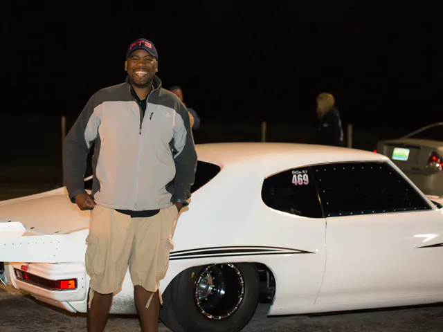 Street Outlaws fan Travis Davis poses with Chief's GTO in the staging lanes at Huntsville Dragway.