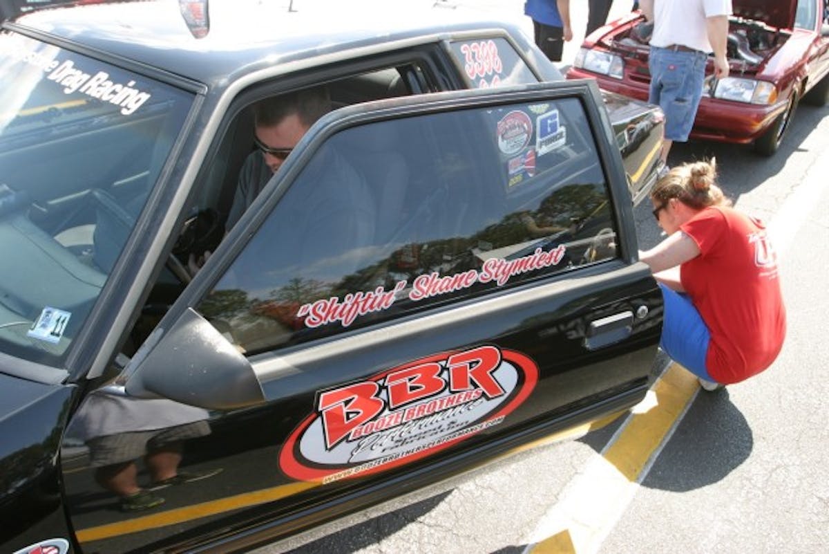 Shiftin' Shane Stymiest has gone Hollywood on us. He sits in the car while his girlfriend Bobbi Jo Rector checks air pressure. 