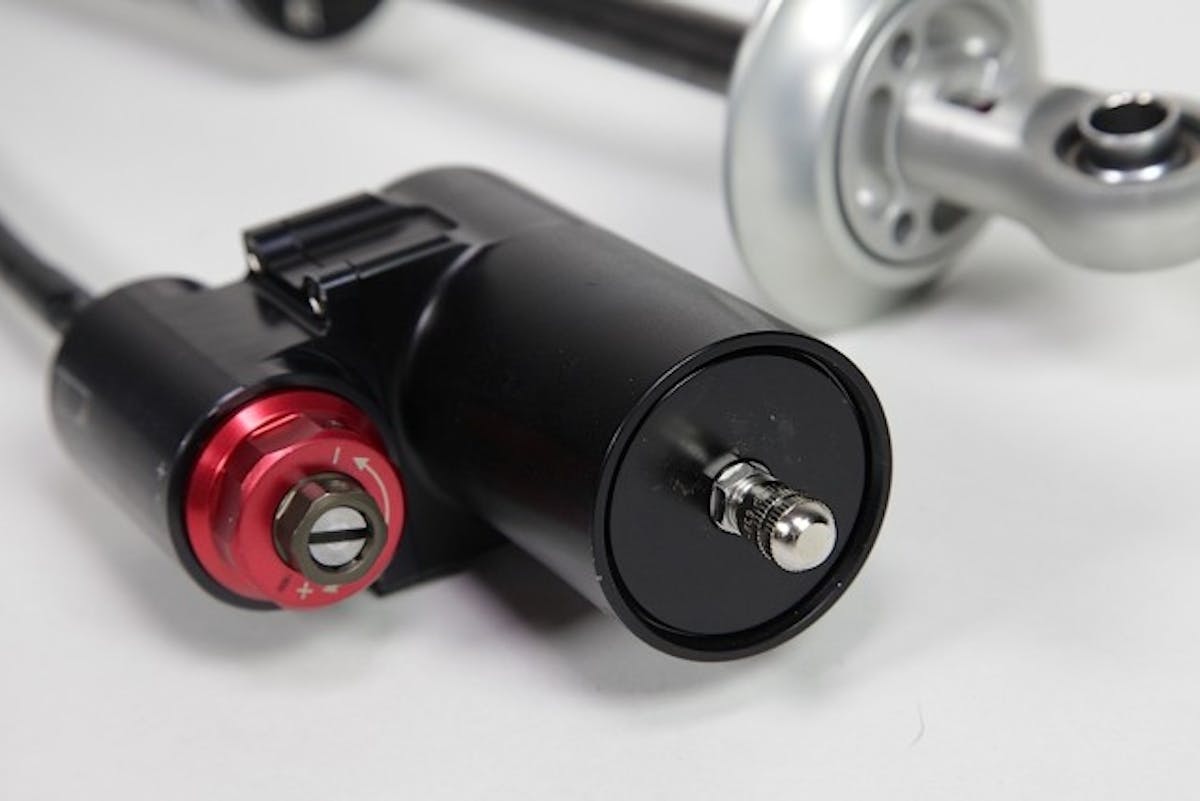 The 4-way adjustable shocks' compression adjustment is on the canister. The 4-way has both high- and low-speed compression and rebound adjustment. These are advanced shocks. Like Lawrence tells us, you can really get yourself turned around, and going in the wrong direction, unless you have a working knowledge of your car's suspension.