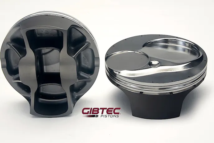 These GibTec Pro Stock pistons are three years old but offer a glimpse at the design factors needed for durability and low friction. Note the extensive support at the pin boss, narrow ring grooves and shallow skirts. Engine builders have options such as the number of gas ports and oil drain-back holes, depending on their needs.