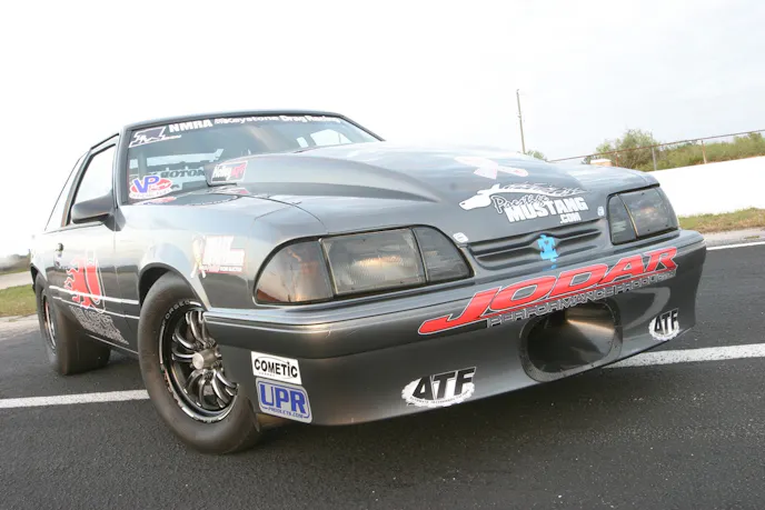 Richard Garrett laid down the Dark Shadow grey on Tobener's coupe. A Schoneck Composites hood and front bumper cover take center stage in this image.