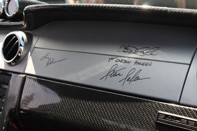 The three signatures on the Saleen's dash is Liz Salen, Steve Saleen, and Sigala's.