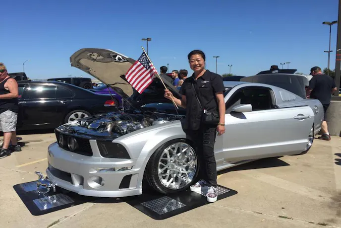 Sue from ASM Upholstery from the show Fast N' Loud did the car's headrests. Here she is with the car at a show.