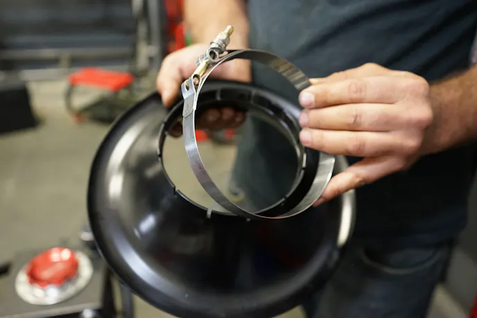 ProCharger 's bellmouth use a simple T-bolt clamp to mount on the supercharger head unit. The company's engineers went for a tight fit to keep the inlet from rattling loose. According to Shifman, some heat is actually necessary to expand the inlet just enough to fit it over the blower for installation.