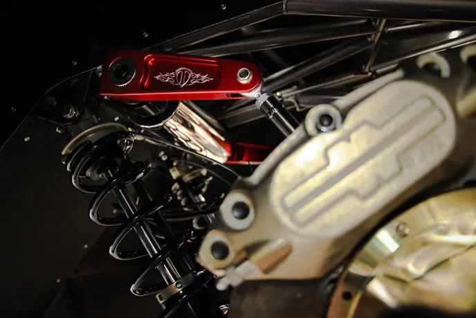 A Tim McAmis extreme duty anti roll bar system installed in a Pro Mod car. The 3" main tube is chrome and the billet 7075 aluminum arms are show in red. At the end of the ARB arm, you can see the connector link and rod end that connects to the rear differential.