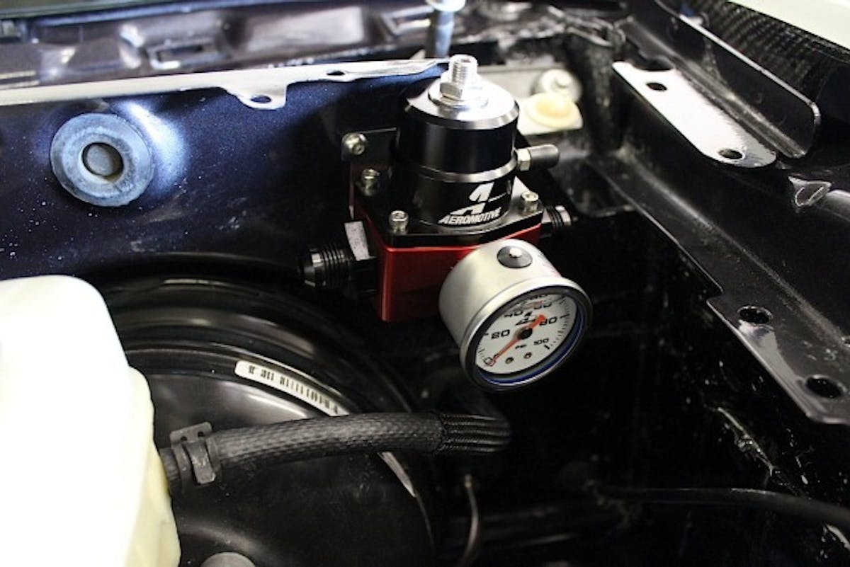 We mentioned possibly the toughest part of a fuel system install is finding a place to mount the fuel pressure regulator. On an S197 car, sometimes the best place to mount it is the driver side firewall area like in this image. This is primarily where most people mount the regulator.