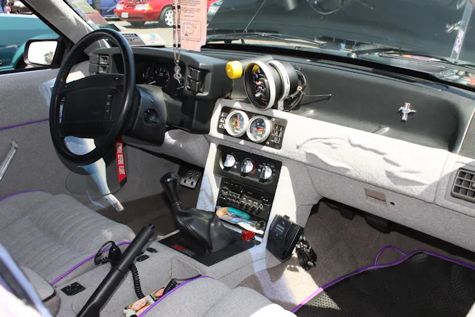 Bruce's friend Michael Cox did the car's tweed interior, relocating the window and door lock switches to the console area. Notice the vintage cell phone mount.