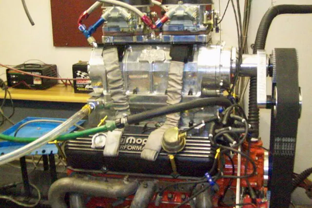 Here you can see the intercooler underneath the supercharger. The water feed line is at left.