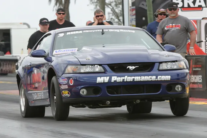 The car itself is actually a body-in-white that Charles owned initially, but sold to Tim Matherly when life got in the way of building a race car. Then Charles bought it back to go Coyote Stock racing, and Matherly moved up to Renegade. The car wears Cobra body panels, and Carnes Customs Sonic blue paint.