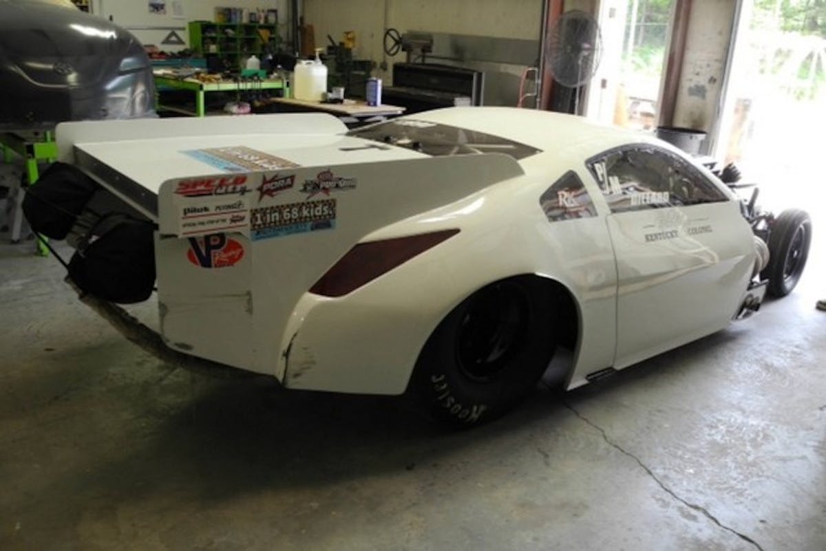 The right rear part of the wing, and right rear parachute mount received damage when the rear end came around, making contact with the wall. VPRC will be repairing this area, as well, grafting in a new parachute mount.