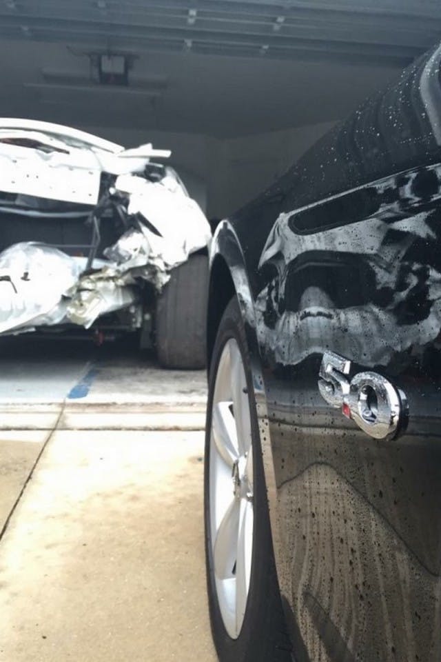 With the new car in the foreground, the original Snow WhiTTe GT is in sad shape in the background. Declared a total loss after getting rear-ended, Jordan bought the car back to salvage what could be saved, and used on the new car.  