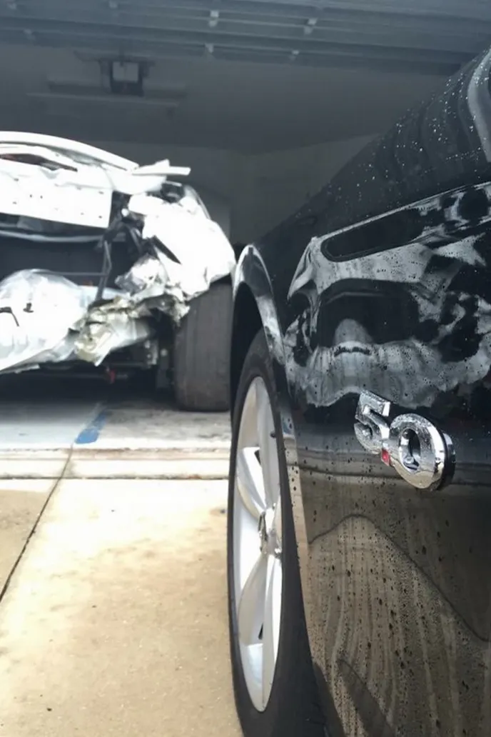 With the new car in the foreground, the original Snow WhiTTe GT is in sad shape in the background. Declared a total loss after getting rear-ended, Jordan bought the car back to salvage what could be saved, and used on the new car.