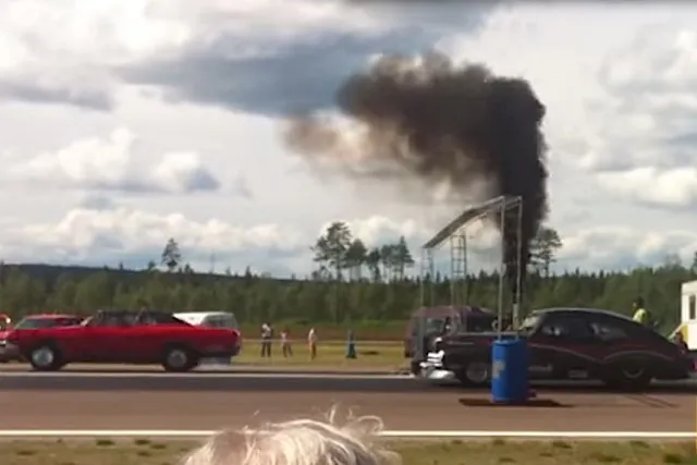 The Cadillac trailing by two car length off the line.