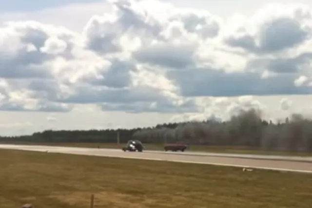 Pulling around the red muscle car the Cadi looks to take the win.