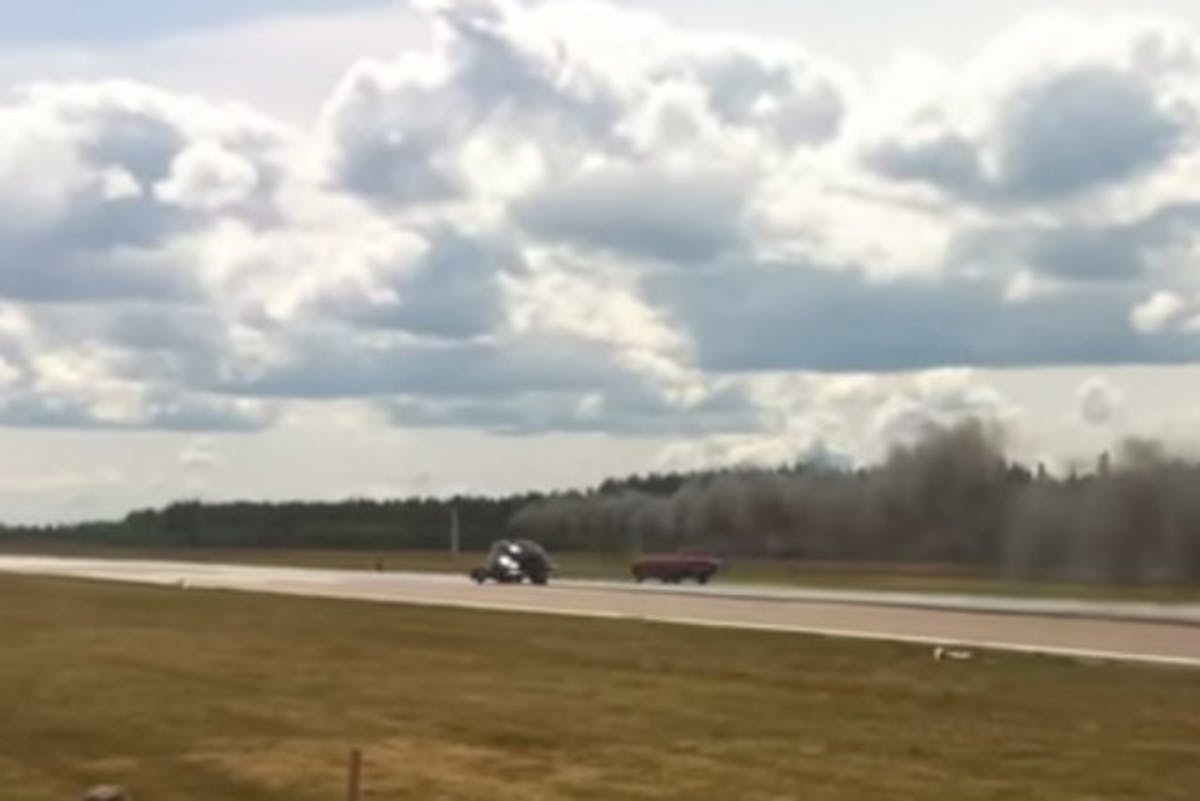 Pulling around the red muscle car the Cadi looks to take the win.