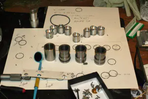 Pistons and cylinder liners atop one of Harlow's sketches.