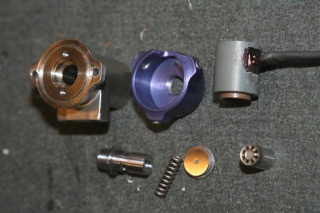 Various parts of the fuel injector assembly.