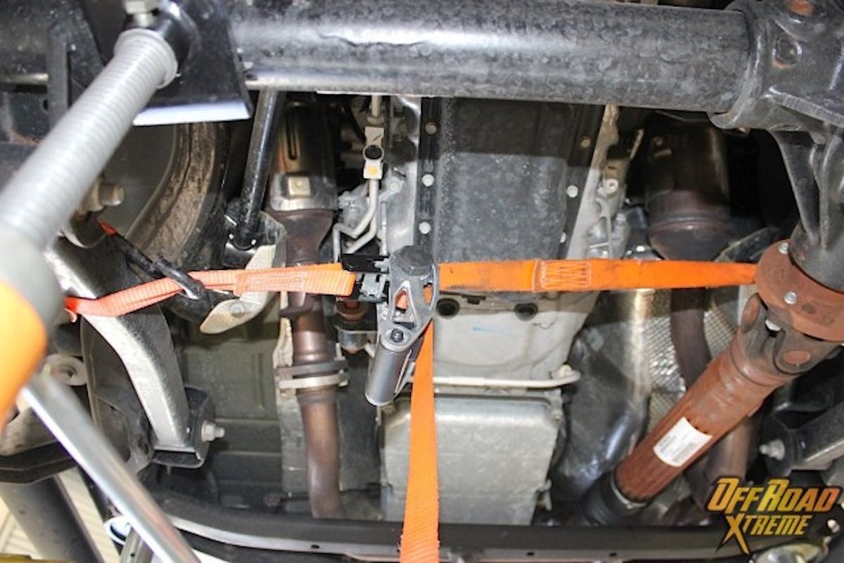 A ratchet strap was used on the front axle to keep it from swinging out, as well as free up movement.