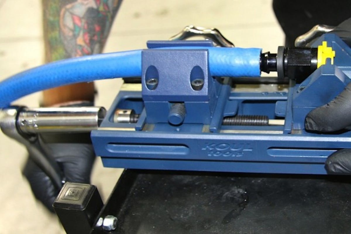 Here you see the use of a hand ratchet, but using a battery-powered ratchet or small impact will make quick work of putting together fluid lines.