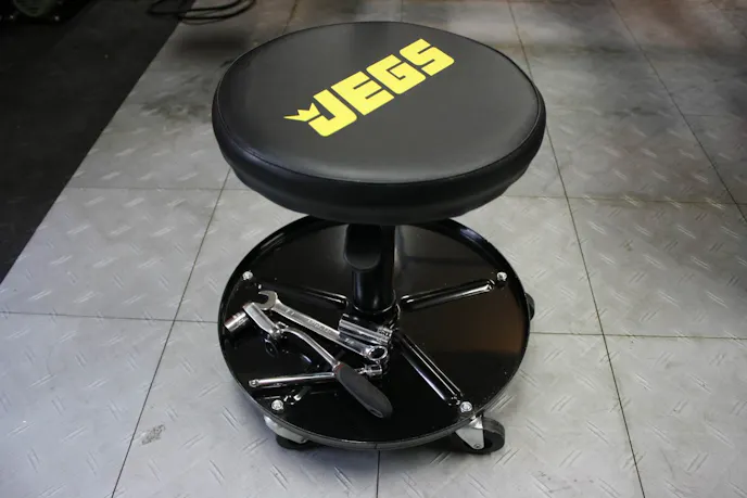 The air seat has a tray that comes in handy for holding tools while working on the car. With the tools in the storage tray, you won't won't run over your tools with the seat.