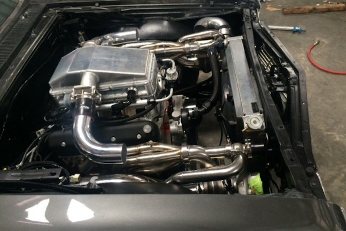 Behind the potent 427 LSX combo is a Hughes Performance-built Powerglide with a PTC converter and Circle D flex plate. The intake you see here was built by Blake Hughes at 417 Motorsports.