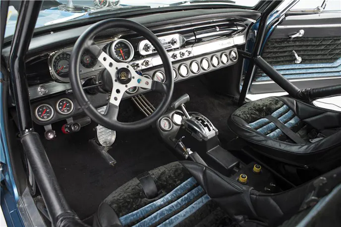 The interior screams fast. Two custom-built buckets are installed inside of a full roll cage.