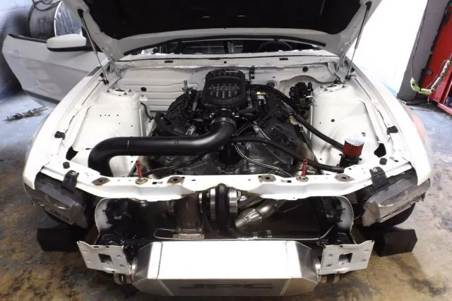 That's a Rich Groh-built Coyote engine with a JPC Racing custom turbo system for a power adder. 