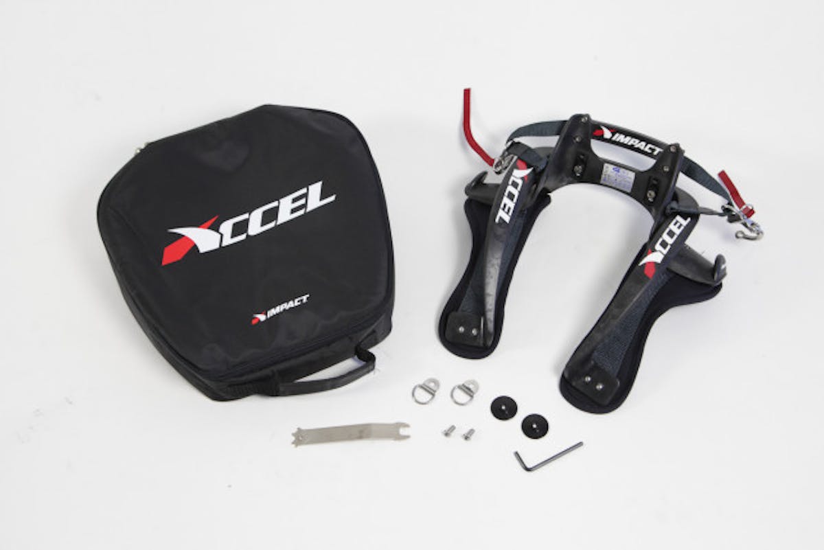 Impact's Accel front head restraint, shown with its storage bag and the necessary hardware for proper functionality.