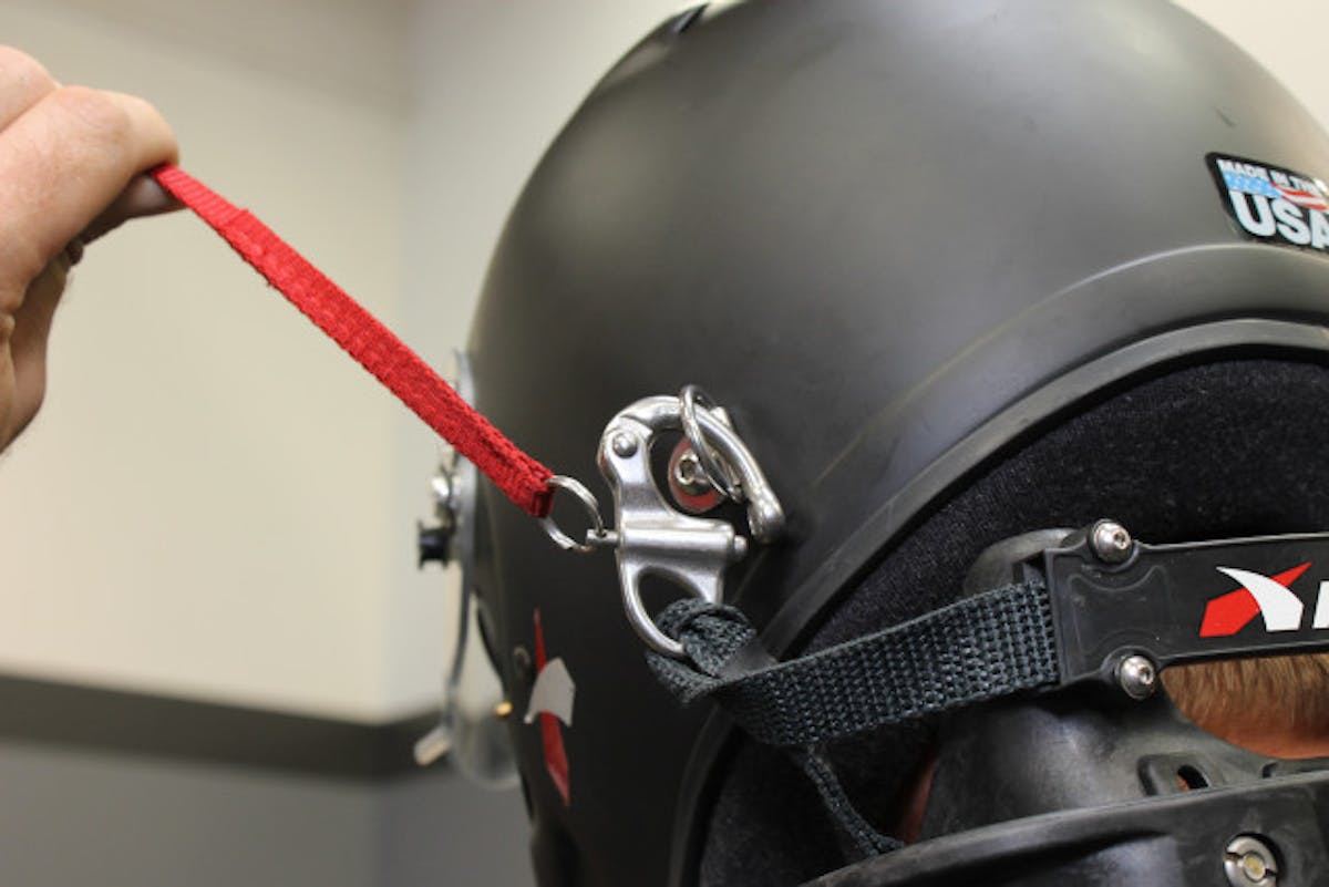 The tether release cords, which are also mandated as part of the SFI approval process, allow the driver to quickly release the helmet from the device.