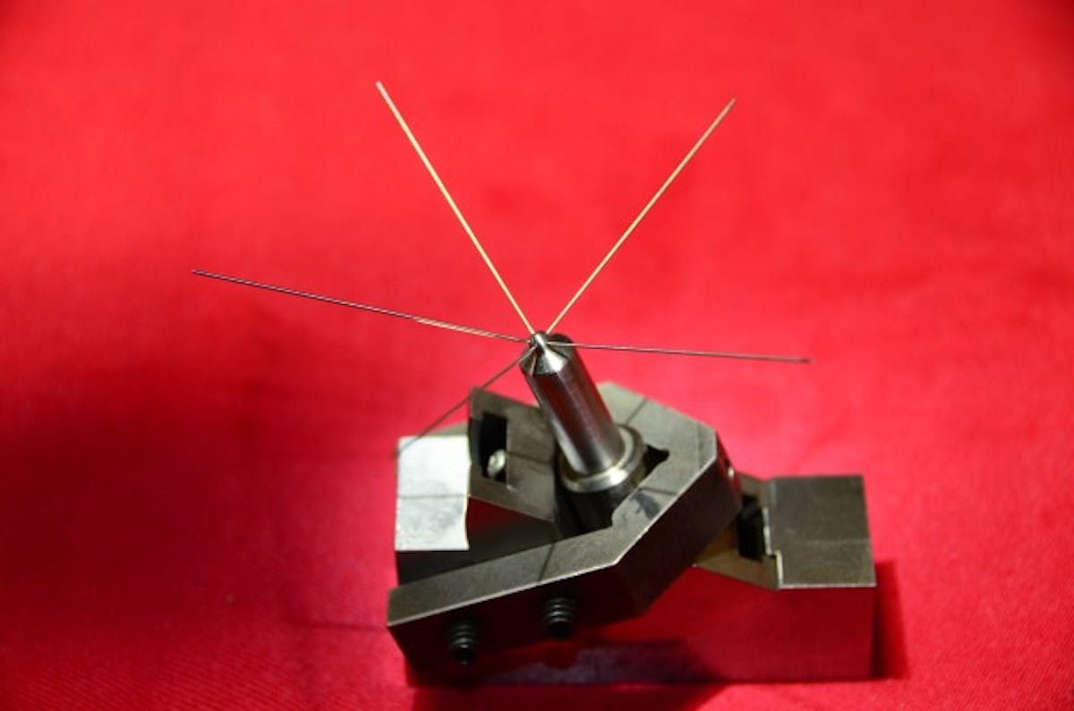 This holding fixture with wire pins are for evaluating the spray angles, which form a funnel-shaped flow onto the piston, typically at 142 to 160 degrees for stock to mild applications.