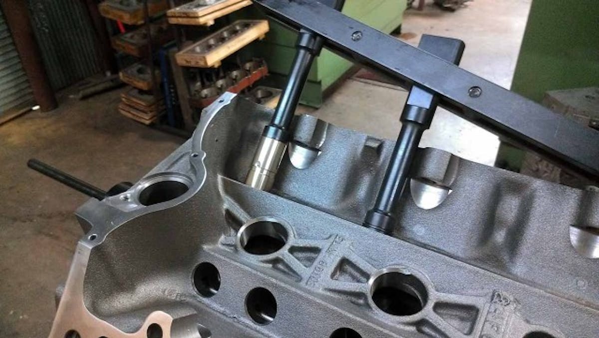 Installing the bronze lifter bushings into the block.