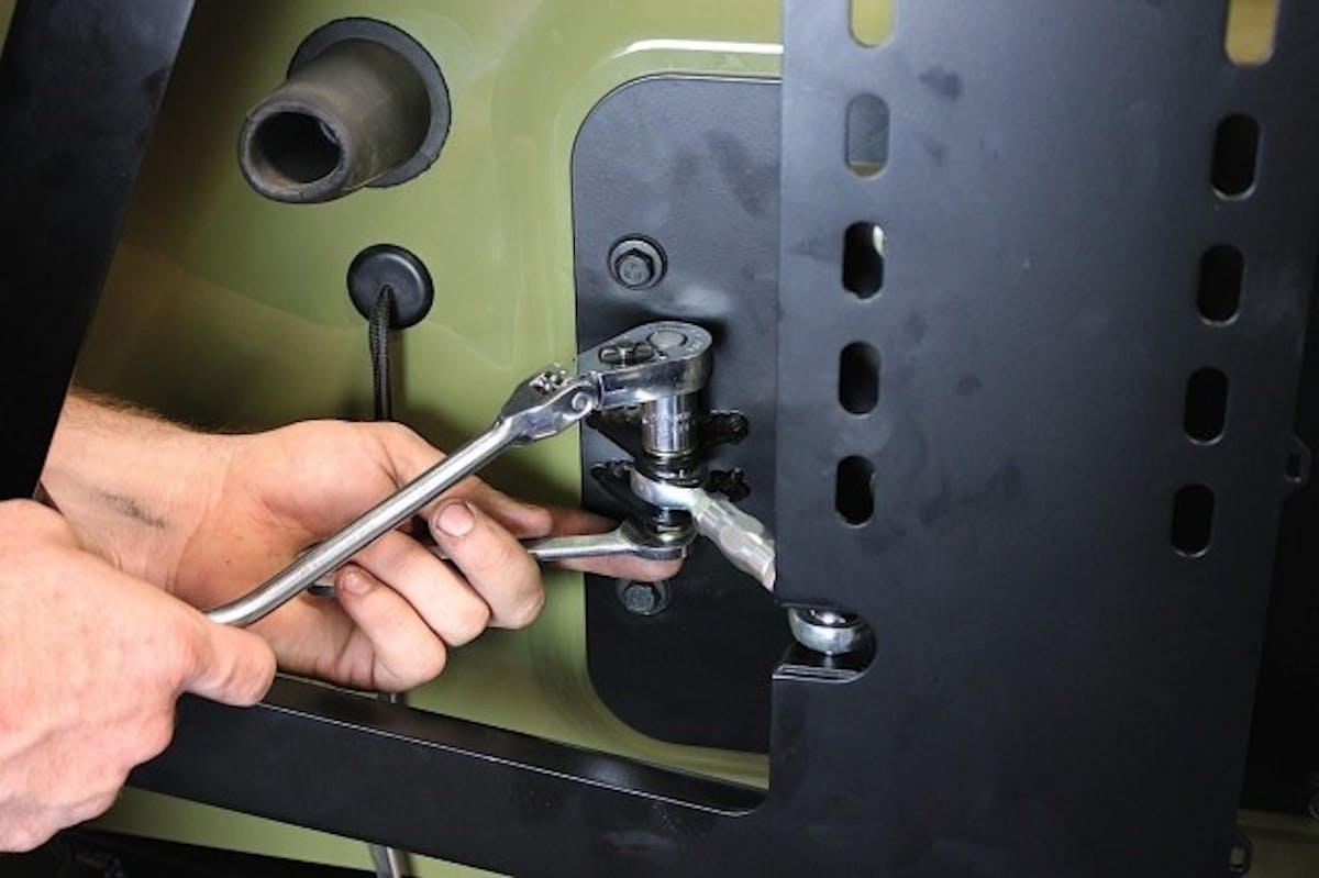 Once the V-alignment bushing and bracket are mounted, the turnbuckle can be mounted and adjusted to pull the V-alignment plate and bushing together with enough force to keep the carrier assembly tight against the tailgate even when holding a heavy tire.