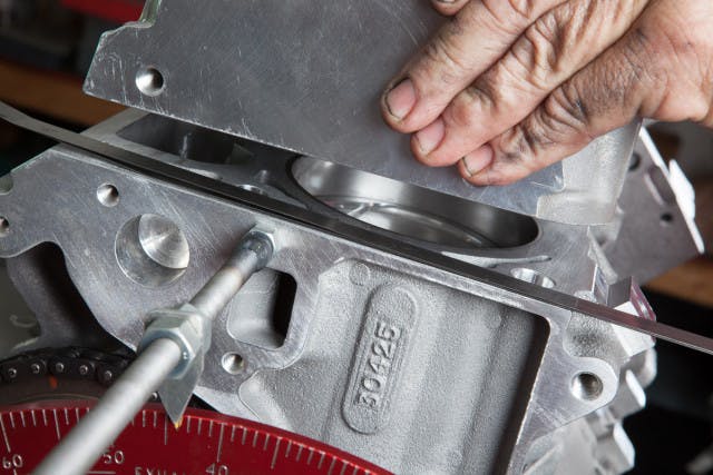 Checking piston-to-valve clearance.