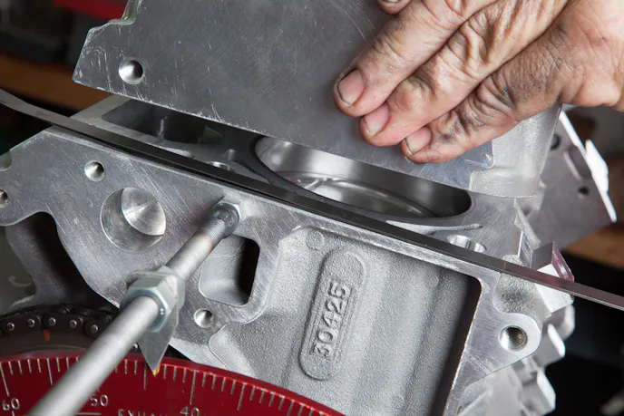 Checking piston-to-valve clearance.