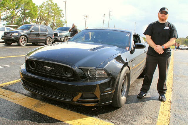 Another racer in the shootout is Justin Jordan. Justin owned the record for the fastest stock Coyote powered Mustang but that car was totalled in an unfortunate accident where Justin was rear ended. The engine was transferred to this car but not after spending some time with Tim Eichorn at MPR Engines where it was fitted with sleeves and upgraded rods and pistons. It's fed by a pair of Precision 64 MM Turbos and backed by a Power by the Hour bujilt transmission and a 35 spline 9 inch rear from Pro Fab Performance. He has already been 8.7's at 164 at the NMRA Finals recently in the first outing with the new car.