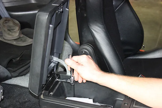 The console lid is hardly a challenge to install.