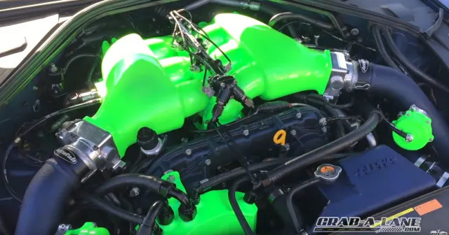 A little peek under the hood reveals more accents in the lime green theme, carried over from the interior.