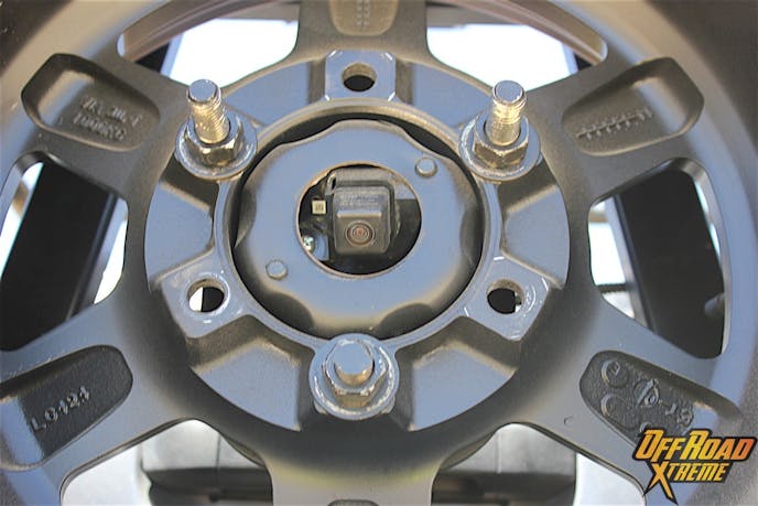 There's a lot of stuff in the way, but Chris can still see thanks to this cleverly mounted camera inside the spare tire mount.