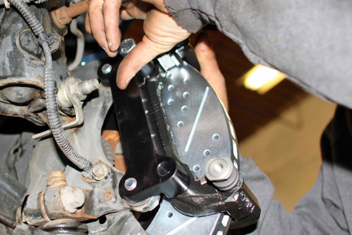 A Baer Sport rotor being installed to improve braking performance.