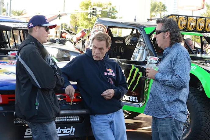 Some talking going on between Bryce Menzies and Pete Sohren, better known as "Pistol Pete," at the SCORE experience at the SEMA Show