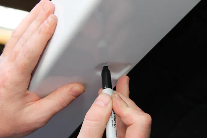 Mark the pilot holes with a crayon or felt pen as shown. The marks on the front fenders should be ten mm, while the rears should be 22 mm in from the edges. Drill the pilot holes using a 3/32-in bit.