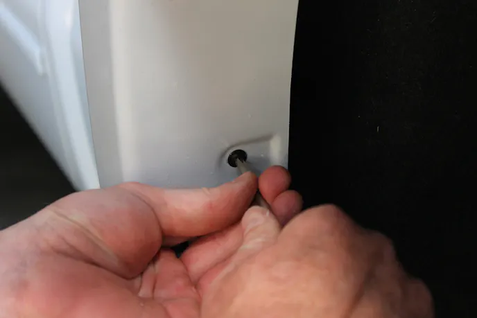 Use the drill to install the screws in an alternating pattern starting in the center and working out. Use a manual screwdriver to make sure they're tight.